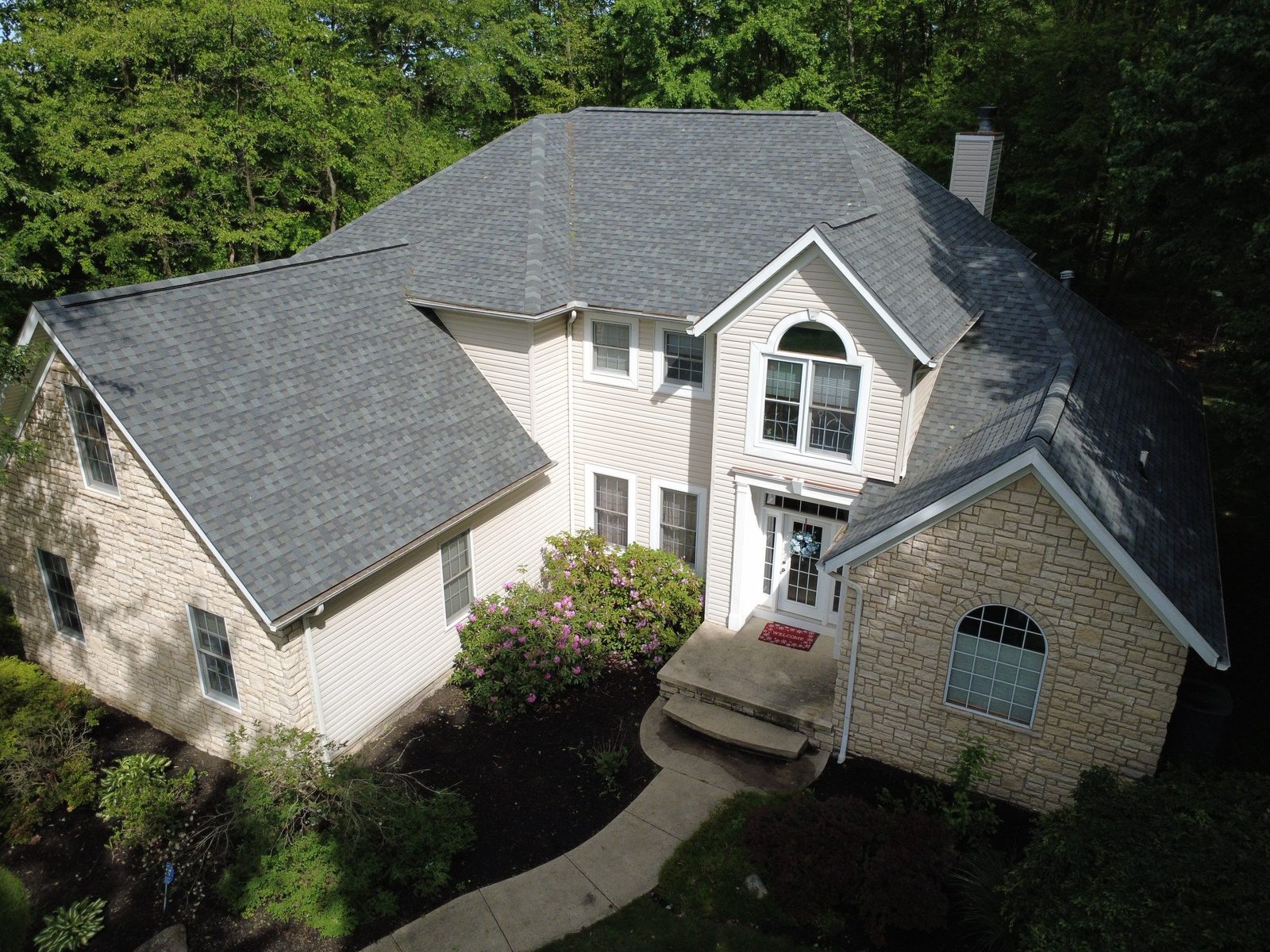 Drone photo of a finished shingle roof on a Doylestown home in Wayne County, Northeast Ohio — Firestone Roofing & Restoration.