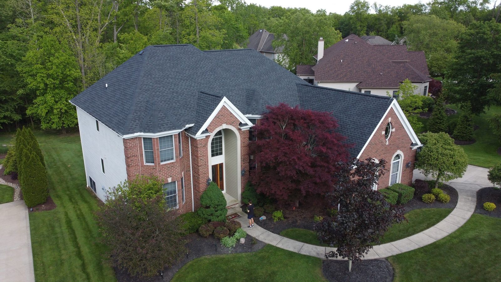 Aerial drone view of a completed roof replacement in North Royalton, Ohio (Cuyahoga County) by Firestone Roofing & Restoration.