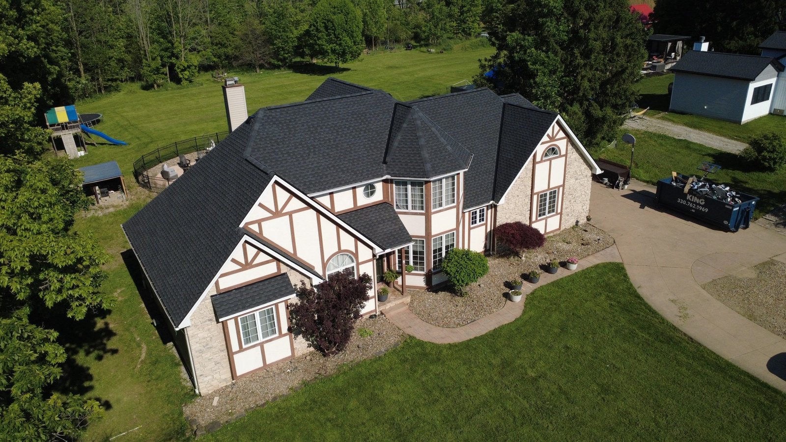 Aerial drone view of a completed roof replacement in Strongsville, Ohio (Cuyahoga County) by Firestone Roofing & Restoration.