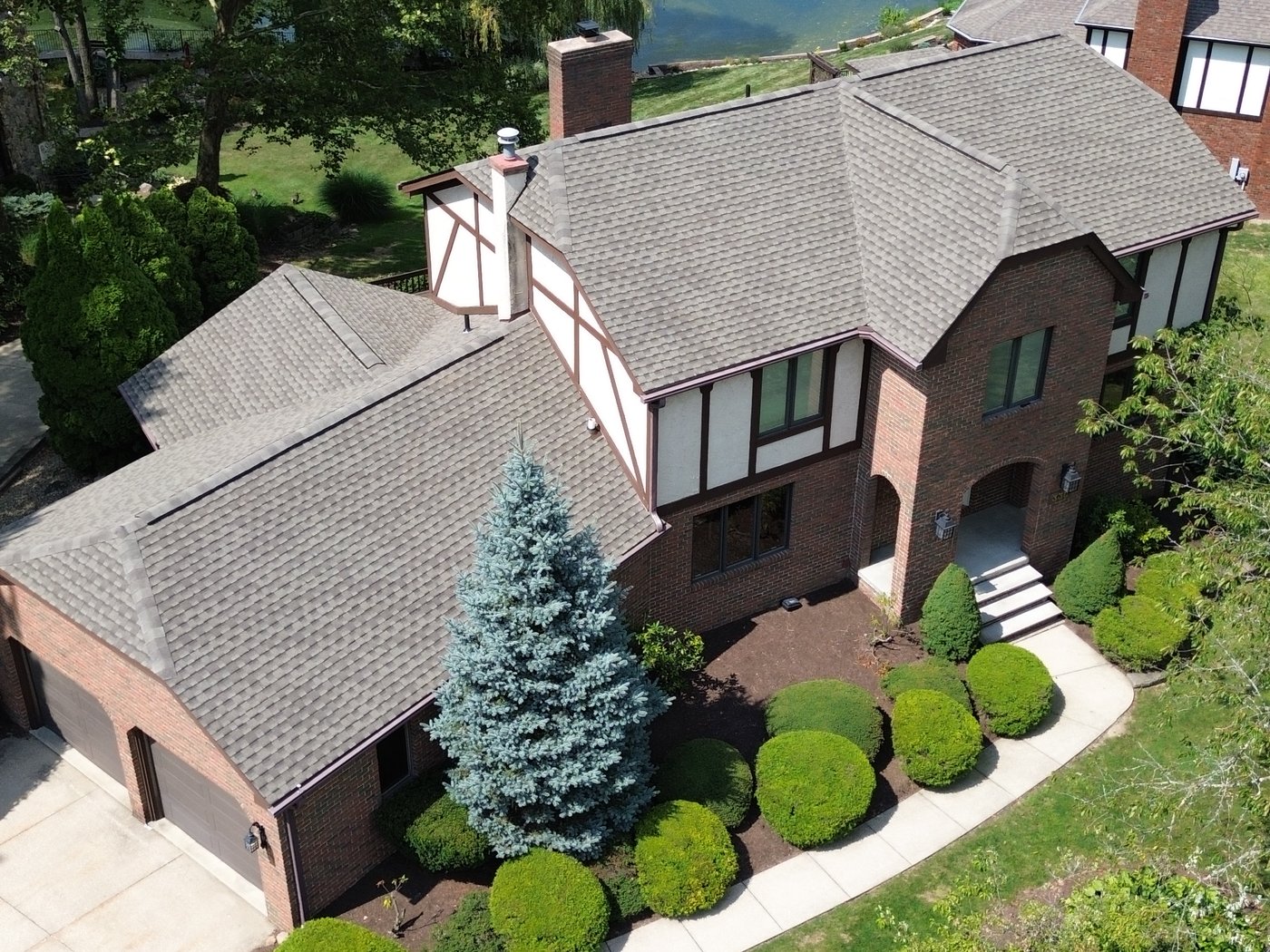 Aerial drone view of a completed roof replacement in Akron, Ohio (Summit County) by Firestone Roofing & Restoration.