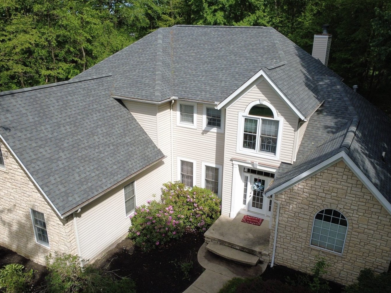 Drone photo of a finished shingle roof on a Doylestown home in Wayne County, Northeast Ohio — Firestone Roofing & Restoration.