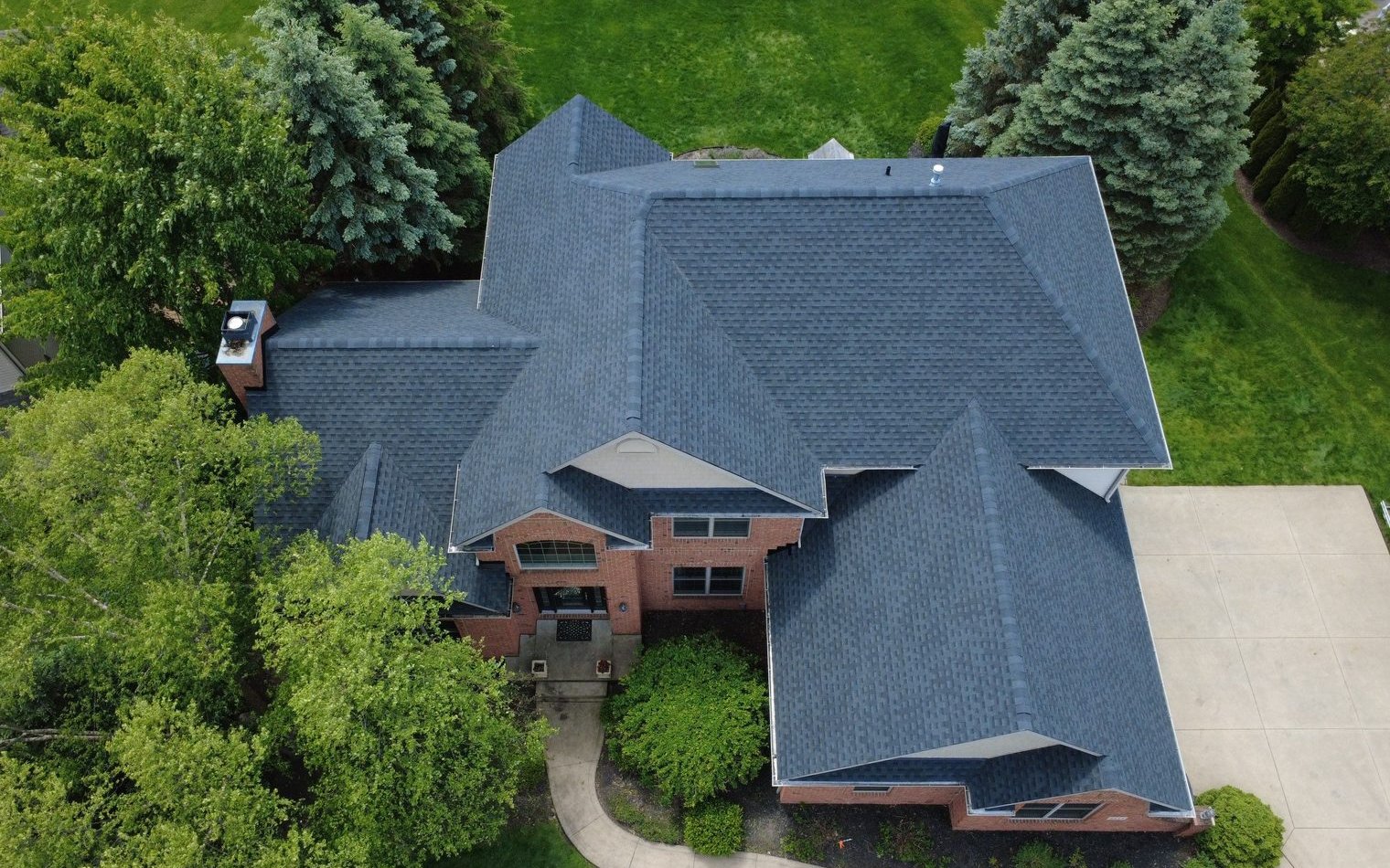 Aerial drone view of a completed roof replacement in North Canton, Ohio (Stark County) by Firestone Roofing & Restoration.