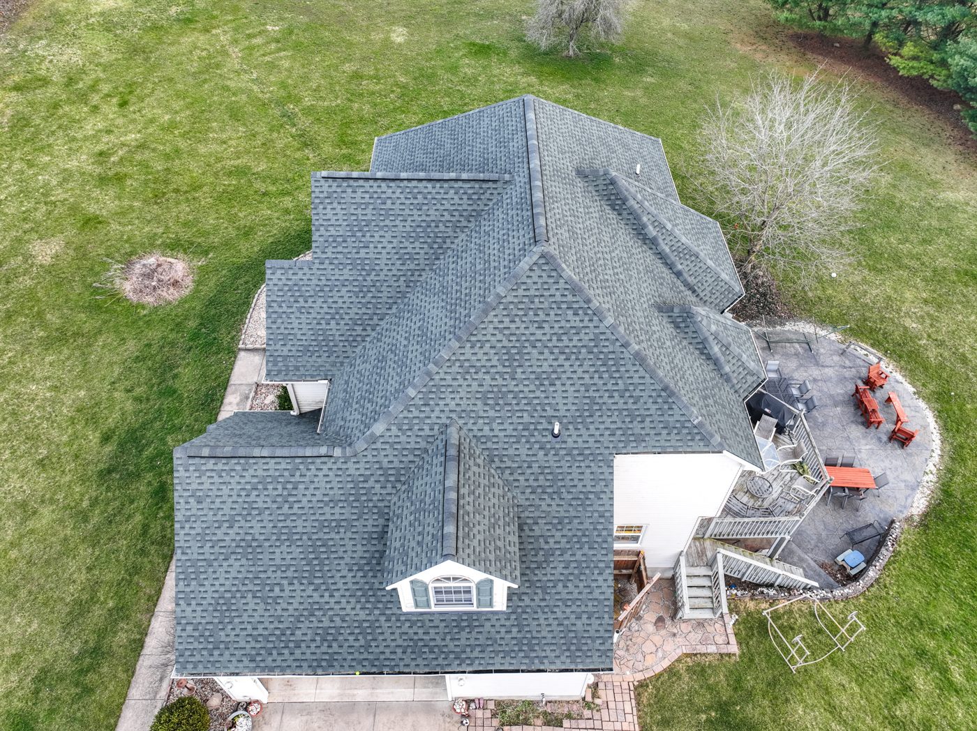 Aerial drone photo of a large completed gray shingle roof with multiple gables and dormers in Northeast Ohio