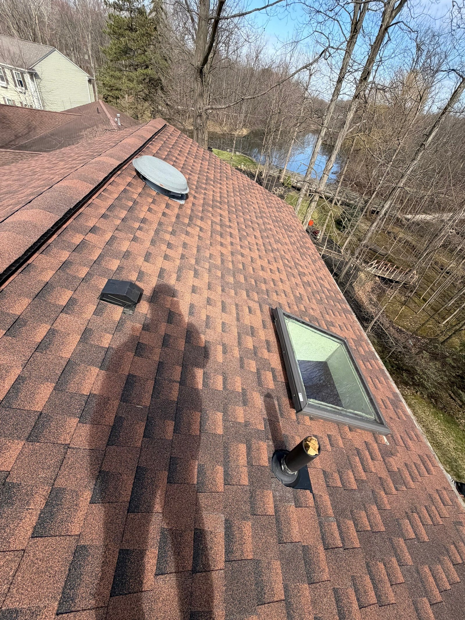 Close-up aerial drone photo of a newly installed shingle roof on a Northeast Ohio home — Firestone Roofing & Restoration.